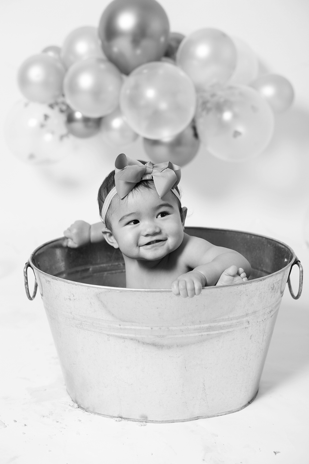 little girl sitting in a tin bath