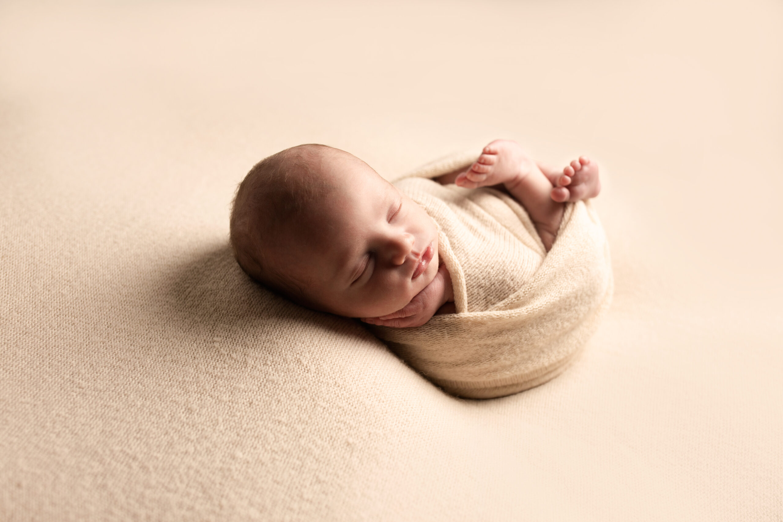 Wrapped baby lying on side