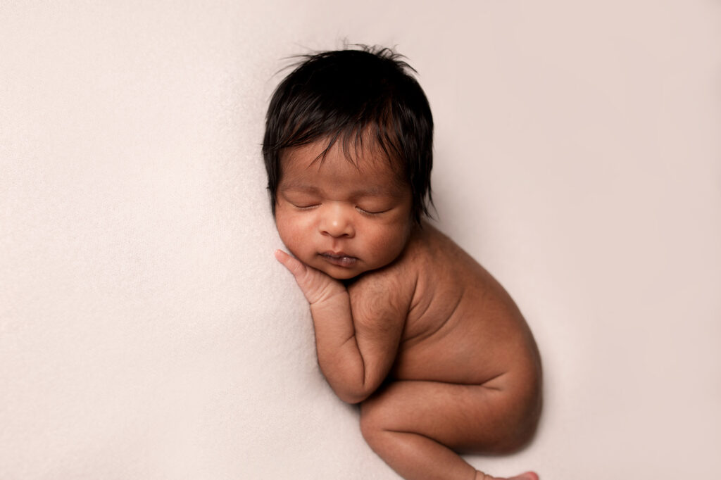 baby boy on blanket newborn posing